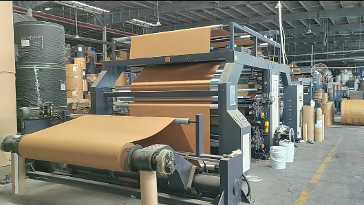 Kraft paper web running through a printing and coating line in the Handingsheng workshop
