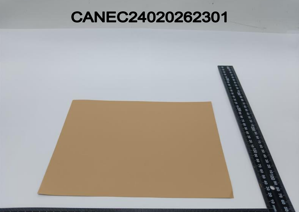 Red kraft paper sample sheet photographed beside a steel ruler